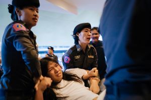 A student demonstrator is arrested and carried away by female police officers following a protest in Bangkok, Thailand.