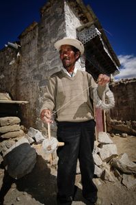 This man was walking through the lanes in Junpa Village, Tibet spinning wool into yarn. Photographed 30 June 2005. © Forest McMullin