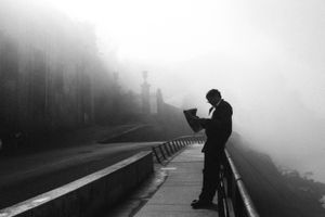 Reading the newspaper on a foggy morning