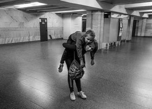 'Mother and Tired Daughter at End of Line Following Long Weekend Journey'