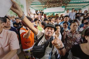 A prospective voter argues with election officials after being prevented from accessing the ballots by anti-government protesters.