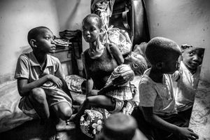 19 year old Evelyn Akinyi and her children in their one-room home in the slums of Malindi on the north coast of Kenya, paid for by the Catholic Church.
