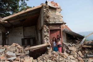 Dipa(left) and Parboti are sister, stand in front of their broken house in Gorkha district, Nepal.