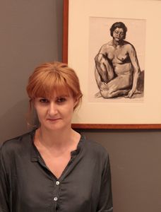 Writer Ana-Maria Sandu in front of the ink drawing by Cecilia Cuțescu Storck, © National Museum of Art, Bucharest