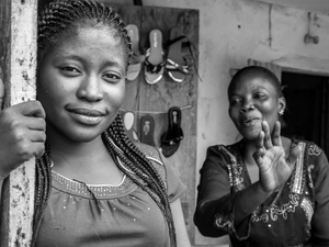 Mother and daughter in front of their shoe shop.