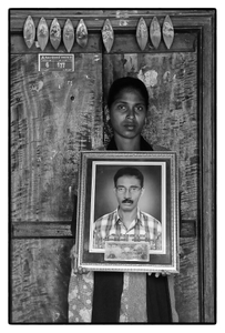 V. Mary with photo of her father Anthony Swamy – a debt-stressed farmer who committed suicide. Tamil Nadu, India.