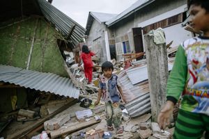 The children playing at their destroyed home due to 6.5 magnitude earthquake in Pidie Jaya, Aceh province, on December 10, 2016.