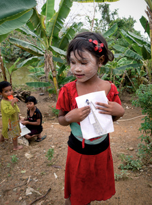 Girl showing her school exercises. Chaung Thar