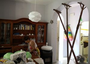 Amalia shows the damages in her house.