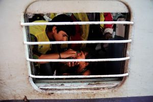 A child is vaccinated by a transit team inside a train in Dadar, Mumbai, Maharashtra