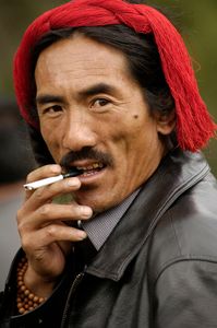 The red string in his hair identifies this man as a Khampa. Khampas are a tribe known to be fierce warriors. They were the main participants in the longest running resistance to the Chinese occupation, funded, in part, by the CIA and partially trained in the US. © Forest McMullin