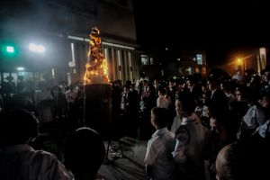 Students of Vizhnits Yeshiva watch as the fire is lit
