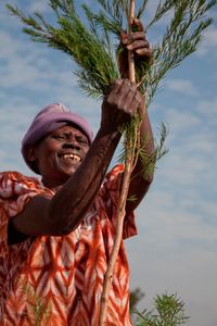 Organic tea tree farmer in Kenya shredding shrub