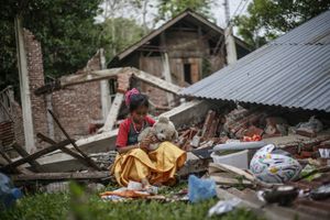Rizka Martunis, 9 years old, hugging her teddy bear as she sitting outside her destroyed home due to 6.5 magnitude earthquake in Pidie Jaya, Aceh province, on December 10, 2016.