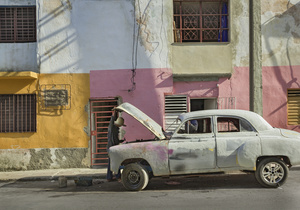 A mechanic works on his vintage Morris Crawley car.
