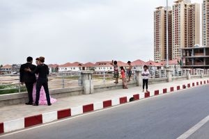 Phnom Penh, Cambodia. Jan 2013. Diamond island, on the Dragon bridge. Bassac Garden City and Rose Condominiums on the background. Is popular among young couples to be photographed near the new icons of the luxury.