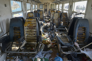 An abandoned train car near Idomeni, filled with trash, the soft padding of the seats cut out for use in tents. March 25, 2016.