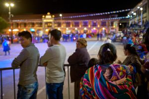 Mother and child at city festival, Calca, Peru