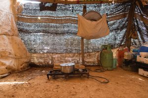 The kitchen area in a make-shift tent in an informal encampment in Neaime. With a dirt floor and made of whatever material was available the tent doesn't provide any protection against the weather, the cold or heat. © David Brunetti