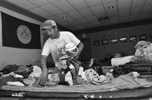 There are no beds or cots in the shelter, so Juan, and the other workers, spread blankets or thin mats on the floor. © Joseph Sorrentino