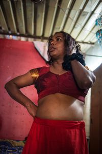 Puja is an energetic and talkative hijra guru, who lives near King's Circle Station, in Mumbai.  She told me that she is raped on average ten days out of every month.  She says, that the police won’t help and she thinks the reinstatement of Section 377 will make the police more likely to treat hijra abusively.  © Alison McCauley