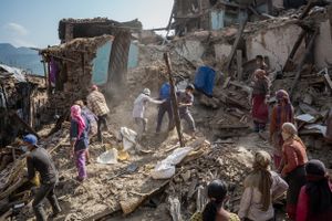 Neighbours search for survivors and salvage belongings from homes destroyed by the 2015 Nepal earthquake.