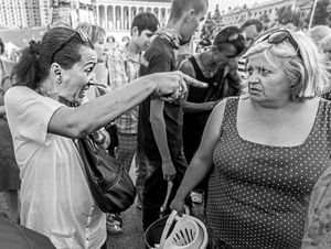 Victoriious citizens argue about what direction Ukraine shold take right after President Yanukoivych was sent to exile from office.  Thney are arguing at Maidan Park,. sitre of a tent encampment for revolutionaries and also near-daily battles.