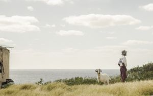 Man, his goat and the sea.