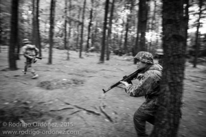 Indonesian men dressed up as German Waffen-SS soldiers run through a pine forest and simulate combat during a gathering of re-enactment enthusiasts in Cibubur, East Jakarta, Indonesia.