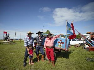 Gauchito Gil devotees next to their carriage, at the national gathering in Mercedes town for  the celebrations of January 8, date of the murder of the popular saint