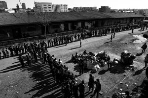 General view on the makeshift shelter where around 1,000 refugee living.Men queue for lunch provided by volunteers at the barracks in Belgrade, Serbia.