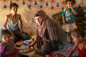 Bekaa Valley, LEBANON, September 5, 2015: Amina with four of her five children in their tent. She is the center of their lives as their father or other male figures are absent. Many refugee women are single parents as their husbands have gone missing or been killed in the Syrian war.