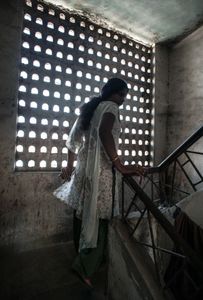 a hijra who lives and works in Thane, Mumbai walks up to the rooms she shares with her hijra group  © Alison McCauley