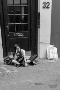 Young girl sitting on pavement, Carnaby Street