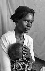 Moments before this image, the pediatrician had told informed this young mother that her child had a fatal heart condition.                                  © Lola Reid Allin