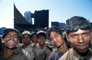 Gang of workers carrying scavenged steel plate from tanker, Near Chittagong, Bangladesh