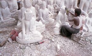 Mandalay, Myanmar, 2013. A sculptor puts the finishing touches to Buddha's face. © Spike Johnson