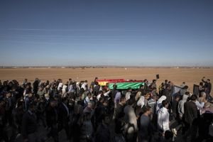 Kurdish people carry the coffins of a People's Protection Unit (YPG) fighter and a Kurdish Women's Protection Unit (YPJ) fighter who died during fighting in the besieged Syrian border town of Kobane, during a funeral in the town of Suruc, Sanliurfa province, Turkey on November 7, 2014.