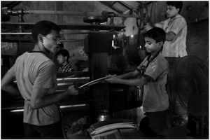 A child labor doing a material-handling job.