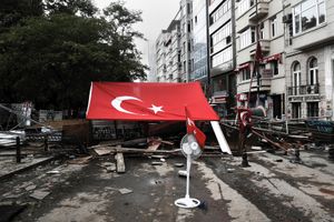 A huge Turkish flag covers a makeshift barricade which blocks the entrance of the police forces at the Taksim Gezi park in Istanbul, Turkey on Wednesday 12th, 2013.