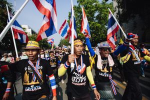 Protesters march in an anti-government street demonstration in Bangkok.