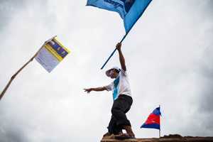 A CNRP supporter waves a flag during opposition leader Sam Rainsy’s return to Cambodia.