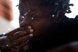 Maya washing herself before getting ready to go to the club for work.