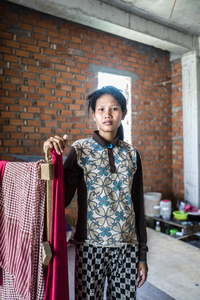 Khang Chet 25, moved to Phnom Penh a year ago with her husband and daughter. The family stay on the construction site. Chet is concerned for her family's welfare and despite the construction company offering health care she is unaware what would happen if she was seriously injured.