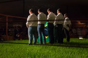 In a conservative and patriotic ambiance, cowboys sing the national hymn in a private luxury cattle's auction opening during ExpoZebu Cattle Fair.  Uberaba, Brazil, 2013