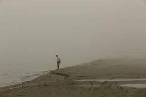 Man standing at the shore.