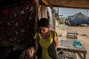 Chhiek Na 30 from Svay Rieng Province came to work in Phnom Penh with her husband and son Ouh Vanny who is four years old. The family migrated due to a lack of work in the home province. Na's husband has fallen from the  buildings but was lucky and unhurt.