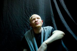 A quiet corner backstage, 20 year old contestant Simon Gachucha, "I feel strong". Albinos often suffer low self-esteem, cover their faces, and keep their eyes low away from bright lights.