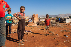 Bekaa Valley, LEBANON, September 5, 2014: Boys play in their destroyed settlement. On September 9, 2014, the camp has been destroyed entirely. Ibrahim, the chief of the village, claims it was the Lebanese army who came in search for hidden Daesh/ISIS fighters and weapons. Official reports say it was unidentified gunmen. Sectarian tensions are growing in Lebanon.
