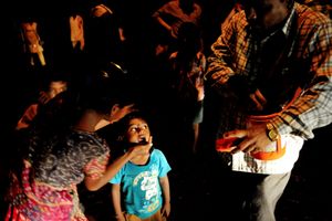 A Night Vaccination team vaccinates children of migrant and homeless laborers under a flyover on the streets of Mumbai, Maharashtra